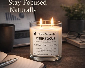 May include: A lit, clear glass candle labeled "DEEP FOCUS" sits on a desk. The candle has two wicks and is surrounded by a notebook, pen, and a laptop. The text "Stay Focused Naturally" is at the top of the image.