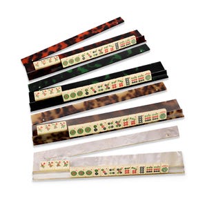 May include: A rustic wooden sign with the text "Welcome" in a handwritten style. The sign is painted white with a distressed finish, and features a decorative floral element in the corner. The background is a blurred image of a wooden surface.