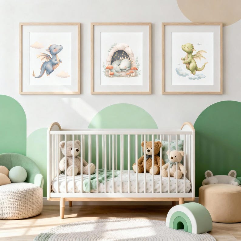 May include: Three framed watercolor prints of baby dragons in a nursery setting. One print shows a blue dragon flying, another depicts a dragon in a cave, and the third shows a green dragon. A white crib with teddy bears is in the foreground.