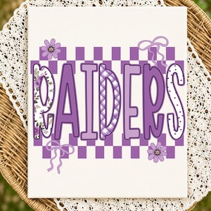 May include: A rectangular canvas print featuring the word RAIDERS in large purple letters. The letters are set against a purple and white checkered background. The design includes floral patterns, a plaid texture, and two purple bows and flowers.