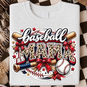 Peut inclure: Un sweat-shirt gris clair à col rond avec une impression graphique portant le texte Baseball MAMA dans une police grasse. Le motif comprend deux battes de baseball en bois, une balle de baseball blanche, des nœuds rouges et des petites étoiles rouges.