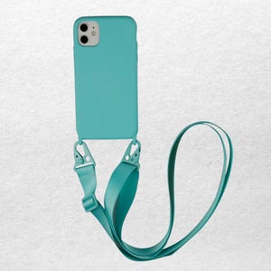 May include: A teal phone case with a matching lanyard. The case is a solid color and has a smooth texture. The lanyard attaches to the case with silver-colored clips and is made of a soft, wide fabric.