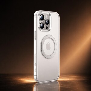May include: Clear phone case with a silver frame and a circular MagSafe ring. The case is designed for an iPhone, with cutouts for the camera and buttons. The Apple logo is visible on the back of the phone.