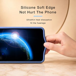 May include: A blue phone case with the text "Silicone Soft Edge Not Hurt The Phone" and "Ultrathin heat dissipation fit the fuselage". The phone displays a blue and black image of the Earth.