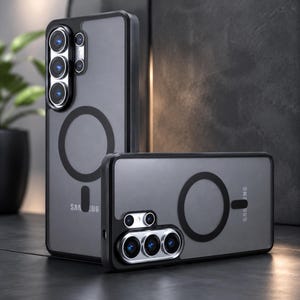 May include: Two grey phone cases with black edges. Each case features a circular design and a camera aperture. The Samsung logo is visible on the side. The cases are displayed in a studio setting.