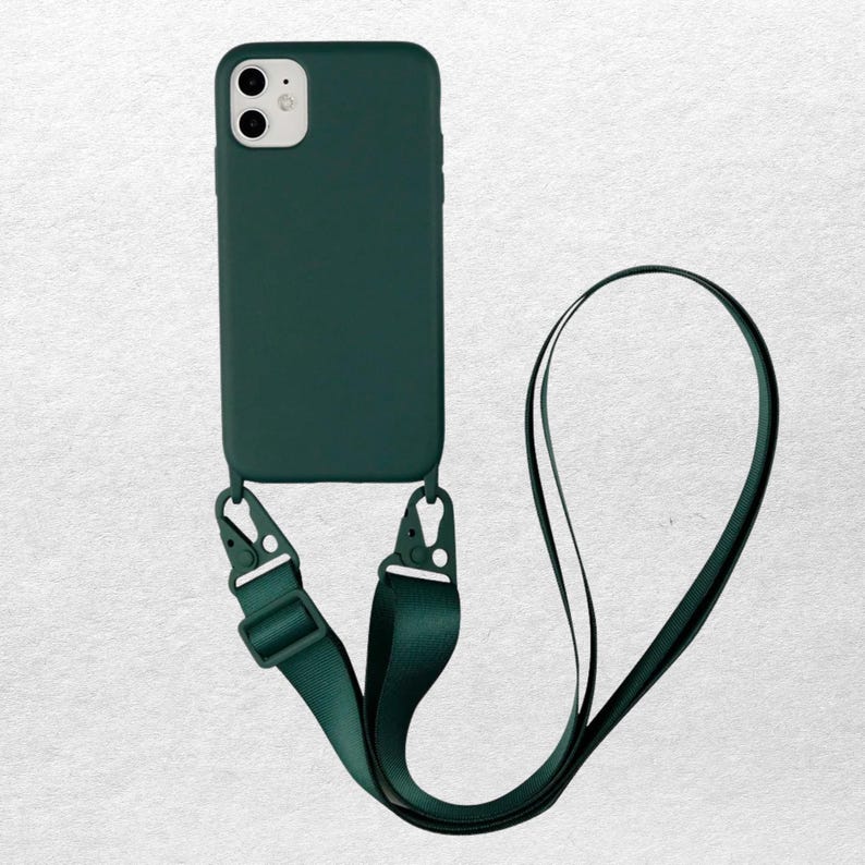 May include: A dark green phone case with a matching lanyard. The case has a smooth finish and is attached to the lanyard with two clips. The lanyard is a long, thin strap, designed to be worn around the neck or shoulder.
