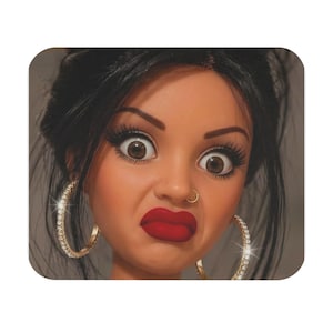 May include: A doll head with dark hair, brown eyes, long eyelashes, and bright red lips. The doll features a small gold-coloured nose ring and large, circular hoop earrings encrusted with clear, sparkling stones that catch the light.