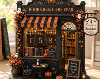 May include: A miniature bookstore display featuring a black facade with orange and black striped awning, pumpkins, and ghosts. The sign reads 'BOOKS READ THIS YEAR' and 'Sophia's Bookshop'. A chalkboard sign says 'Reading Spookily Ever After' and 'Just One More Chapter'.
