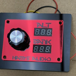 May include: A white ceramic mug with a black handle and the text "But First, Coffee" in a bold, black font. The mug is filled with a dark liquid, likely coffee, and sits on a light-colored surface.