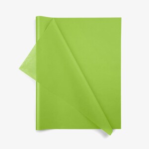 May include: A rectangular sheet of lime green tissue paper with a semi-transparent quality. The paper is folded over at the top left corner, revealing a lighter, more translucent layer of the same vibrant green color against the main sheet.