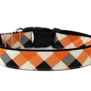 May include: Orange, black, and white plaid dog collar with a black buckle.