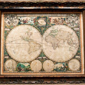 May include: A framed antique-style world map titled Nova Totius Terrarum Orbis Tabula Auctore F. De Wit. The print features two large hemispherical maps surrounded by intricate illustrations of celestial bodies, figures, and decorative floral borders.