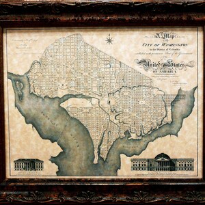 May include: A vintage map of the City of Washington, D.C. in the District of Columbia, established as the permanent seat of the Government of the United States of America. The map shows the city's layout with streets and waterways, including the Potomac River.