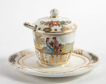 Plato antiguo de cerámica pintado a mano para salsa o mostaza con motivos florales.