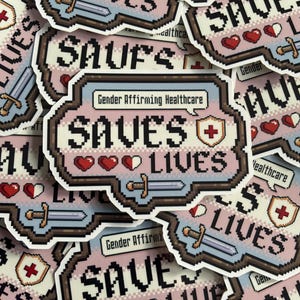 May include: A collection of stickers with a pixelated design. The stickers feature the text "SAVES LIVES" and "Gender Affirming Healthcare" with hearts, swords, and a medical cross. The color palette includes pink, blue, and brown.