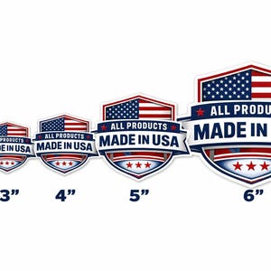 May include: A collection of patriotic stickers in various sizes, ranging from 2 to 6 inches. Each sticker features a shield design with the American flag, red and blue accents, and the text "ALL PRODUCTS MADE IN USA".