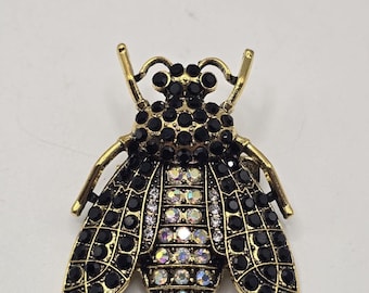 Vintage gold tone bee brooch with black and iridescent rhinestones insect pin