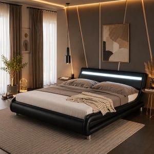 May include: A modern black leather bed with a built-in headboard light. The bed is made up with neutral-toned bedding and a patterned throw blanket. The room has a neutral color palette with decorative accents and a rug.
