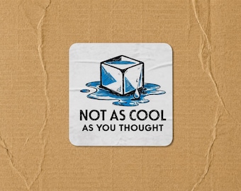 May include: A square white coaster featuring a graphic illustration of a melting blue ice cube in a puddle of water. Below the illustration, the text reads NOT AS COOL AS YOU THOUGHT in bold black capital letters. The coaster has rounded corners.