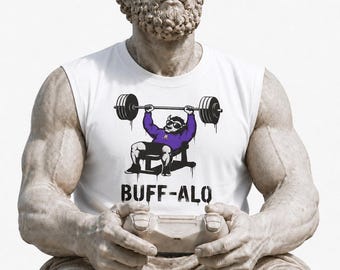 May include: A white sleeveless shirt featuring a graphic of a buffalo wearing sunglasses and a purple shirt while lifting a barbell on a bench. Below the graphic, the text BUFF-ALO is printed in black. The shirt is worn by a stone statue figure.