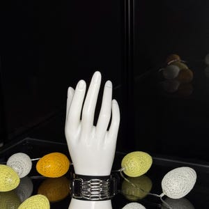 Könnte beinhalten: Eine weiße Keramik-Tasse mit schwarzem Henkel und dem Text "But First, Coffee" in schwarzer, fetter Schrift. Die Tasse steht auf einer weißen Oberfläche.