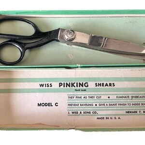 May include: Vintage Wiss pinking shears, Model C, in a green and white box. The shears have black handles and a silver blade. The box text reads "They pink as they cut" and "Made in U.S.A."