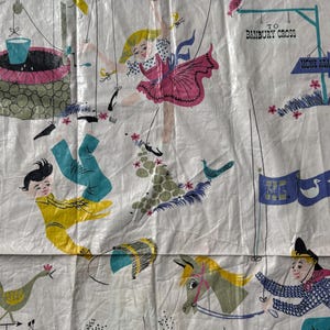 May include: Vintage white fabric with a whimsical illustration. The design features a well, a girl in a pink dress, and figures in yellow and blue clothing. A sign reads "TO BANBURY CROSS". The fabric has a retro, storybook aesthetic.