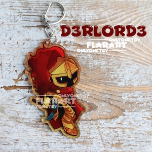 May include: Wooden keychain featuring a cartoon knight in gold armor and a red cape. The knight has a red plume and is holding a sword. The keychain has a silver clasp and a ring. Text on the keychain reads "D3RLORD3" and "FLAR ART".