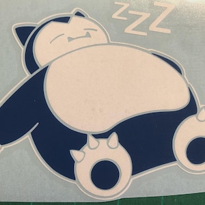 May include: A blue and white graphic of a sleeping Snorlax, a character from the Pokémon series. The image shows the character lying down with the word "zzz" above it in white.