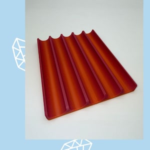 May include: A rectangular tray with five parallel, concave channels featuring a gradient color transition from deep red to bright orange. The image includes the text "Sale" in dark blue and "Item 3" in dark blue against a light blue background.