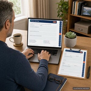 A man is sitting at a desk, working on a laptop computer. The laptop screen displays a form or survey, and there is a clipboard with a similar form on it. The man appears to be focused on the task at hand.