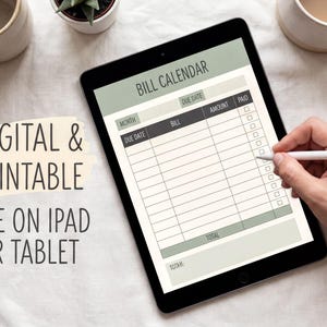 a tablet with a bill calendar app open, and a person's hand is seen writing on the tablet. The tablet is placed on a table, and there are two cups visible in the background.