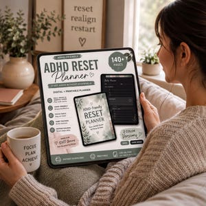 A woman is sitting on a couch, holding a tablet device and a coffee mug, with a potted plant and a candle in the background.