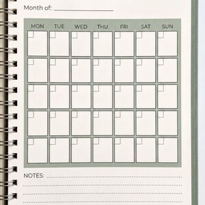 a spiral-bound notebook with a bill calendar page on the front cover. The calendar page has a grid layout with days of the week listed at the top and blank spaces for entering bills and notes.