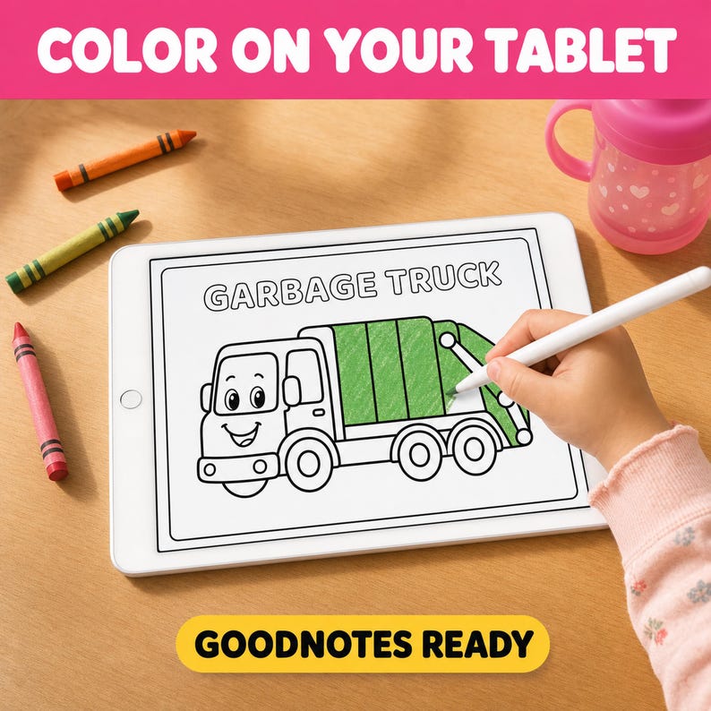A child's hand is holding a stylus and drawing a picture of a garbage truck on a tablet, with crayons and a pink sippy cup nearby.