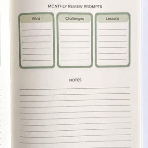 a notebook page with a title "Financial Reflection & Notes" and three columns labeled " Wins", "Challenges", and "Lessons". The page has blank lined pages for writing down notes or reflections related to financial matters.