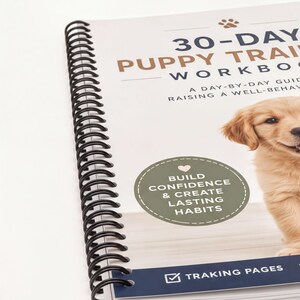 a spiral-bound notebook with a cover featuring a golden retriever puppy. The cover has a title that reads "30-DAY PUPPY TRAINING WORKBOOK" and includes a subtitle that says "A DAY-BY-DAY GUIDE Raising A WELL-BEHAVIOR". The cover also includes a heart symbol and the words "BUILD CONFIDENCE & CREATE LASTING HABITS".
