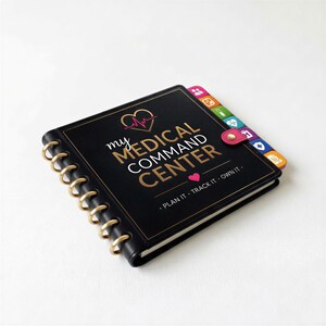 A black spiral-bound notebook with gold rings, titled "my medical command center" and featuring colorful icons on the cover.