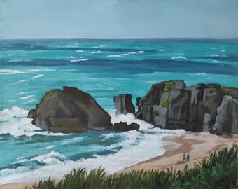 May include: A painting of a rocky coastline with turquoise water crashing against the shore. Two figures are walking on the beach in the foreground.