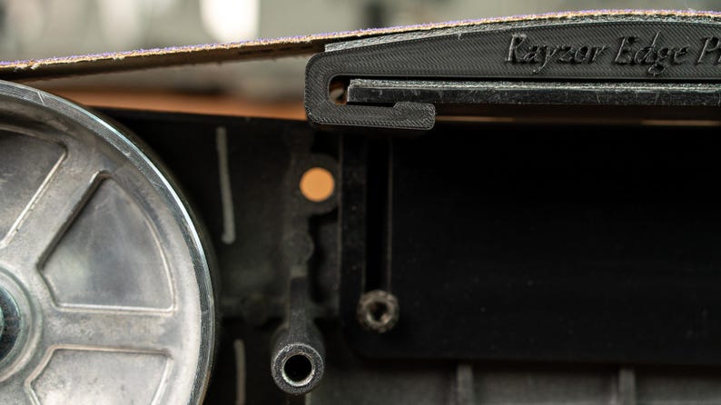 Side view showing the shallow 46 inch curve of the Rayzor Edge platen, ideal for thinning kitchen cutlery.
