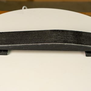 A knife blade being hollow ground on the Bucktool BS242V using the Rayzor Edge radius attachment.