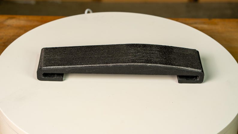 A knife blade being hollow ground on the Bucktool BS242V using the Rayzor Edge radius attachment.