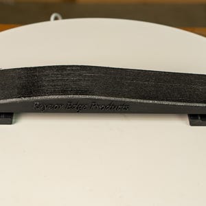 A knife blade being hollow ground on the Bucktool BS242V using the Rayzor Edge radius attachment.