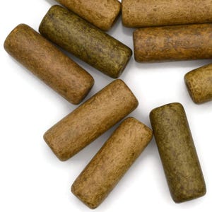 May include: A collection of brown and green wooden beads, each with a unique speckled pattern. The beads are cylindrical in shape and have a smooth, polished finish.