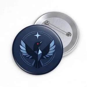 May include: A navy blue badge featuring a geometric bird design with a red eye and a star. The bird is within a white circle and a star. A silver badge back is visible.