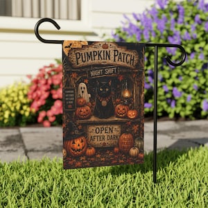 May include: A rectangular garden flag hanging on a black metal stand, featuring a dark illustration of a black cat, pumpkins, a ghost, and a lantern. The text reads PUMPKIN PATCH NIGHT SHIFT and OPEN AFTER DARK, with smaller text listing PUMPKINS, HAY RIDES, HOT CIDER & MORE.