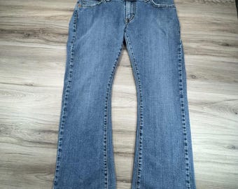 Jeans Levi's 542 Low Flare vintage para mujer, talla 14 M, lavado medio, mezclilla azul elástica, década de 2000, Y2K.