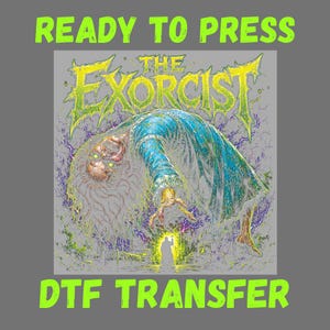 May include: A DTF transfer featuring a graphic of The Exorcist with the text READY TO PRESS DTF TRANSFER. The illustration shows a figure in a blue robe levitating above a small silhouette of a person holding a cross, surrounded by purple energy.