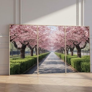 May include: A triptych art piece featuring a pathway lined with blooming cherry blossom trees. The pink blossoms create a canopy over the path, with green hedges on either side. The artwork is framed in a gold tone.