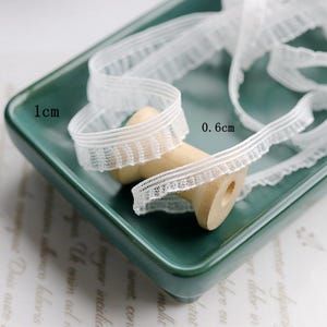 10 Meter 0,6-1cm breit schwarz/ivory Netz elastisch Lotusblatt Rand Spitzenbesatz Baby Kleidung Accessoire Manschetten Vorhang Dekoration C35U45P241225G